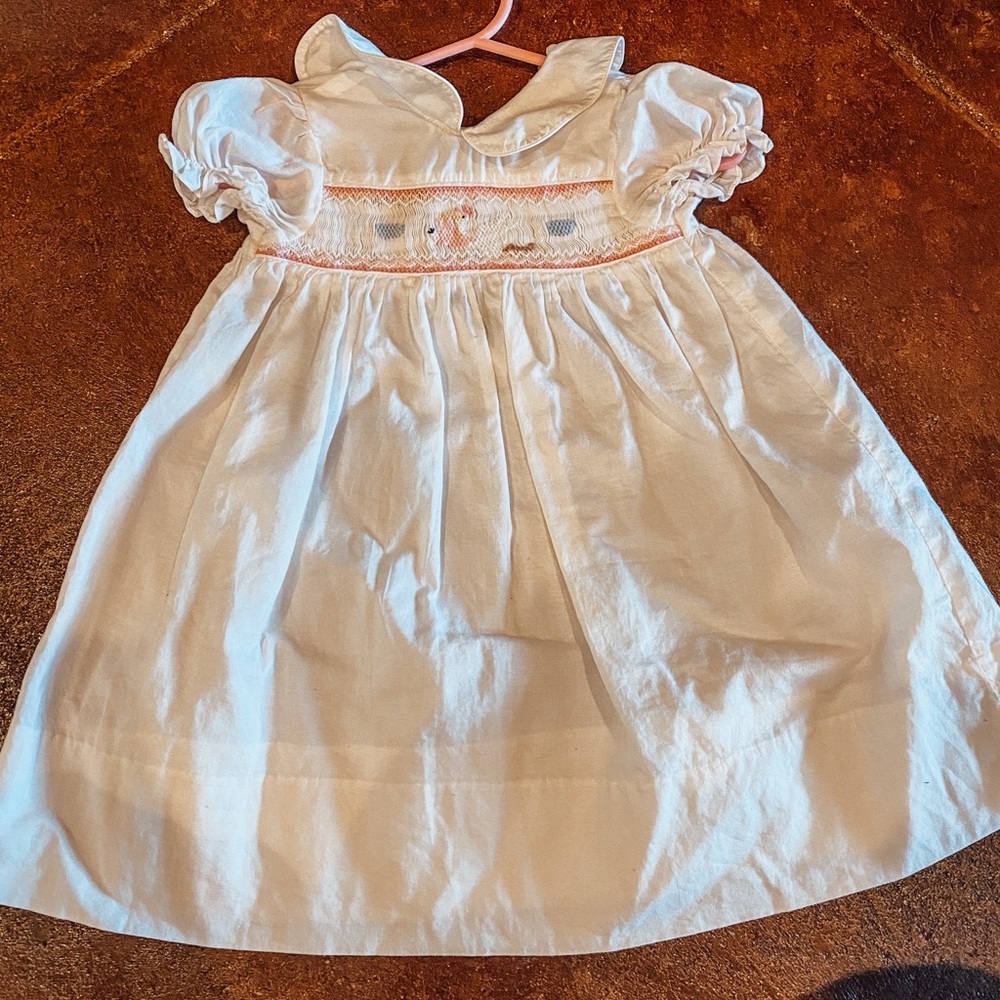 White smocked dress for a baby girl.